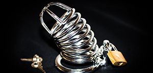 Chastity cage with lock and key.